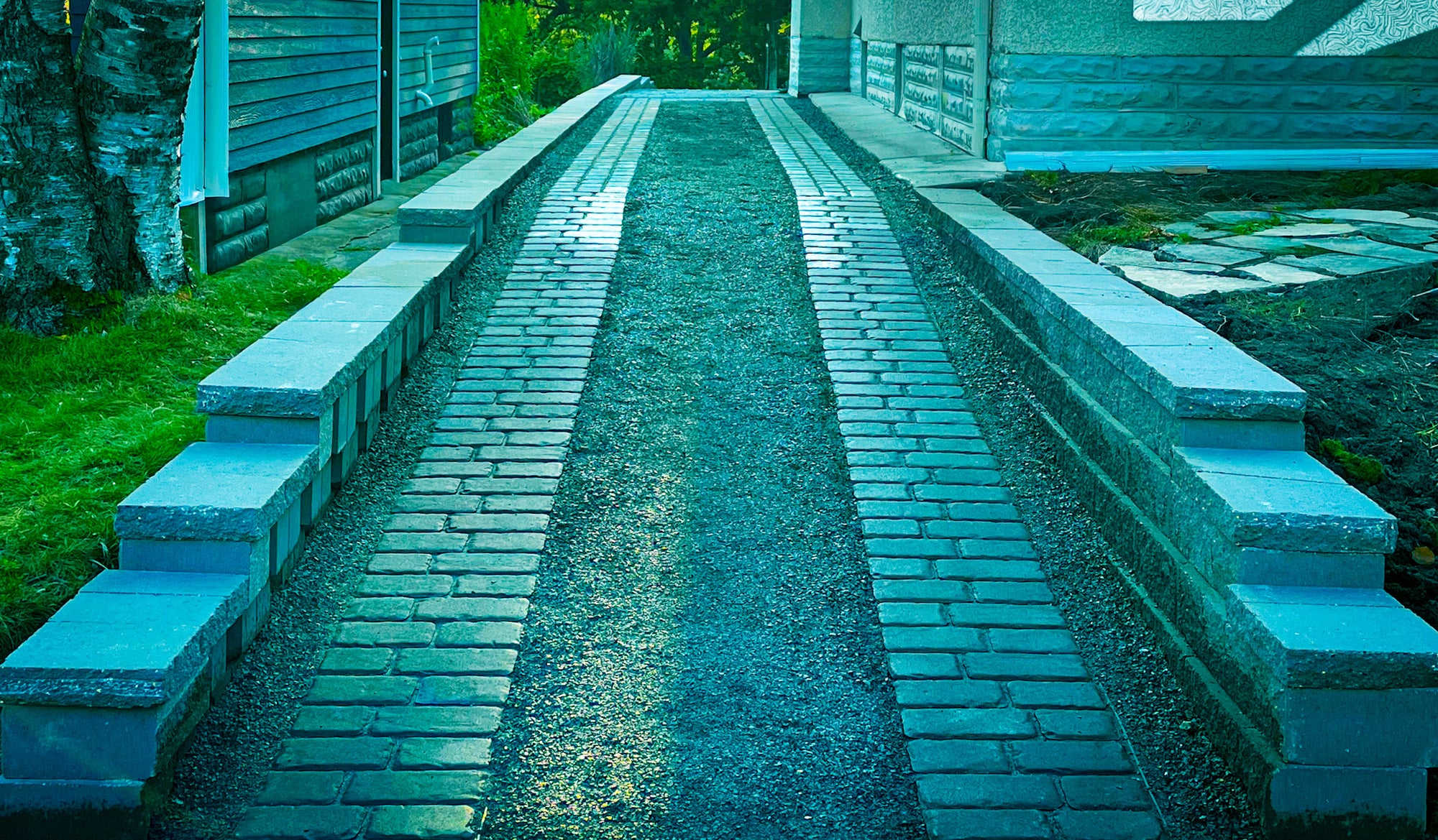 Custom ribbon driveway with concrete and brick pavers by Elzo Landscape in Minneapolis front yard