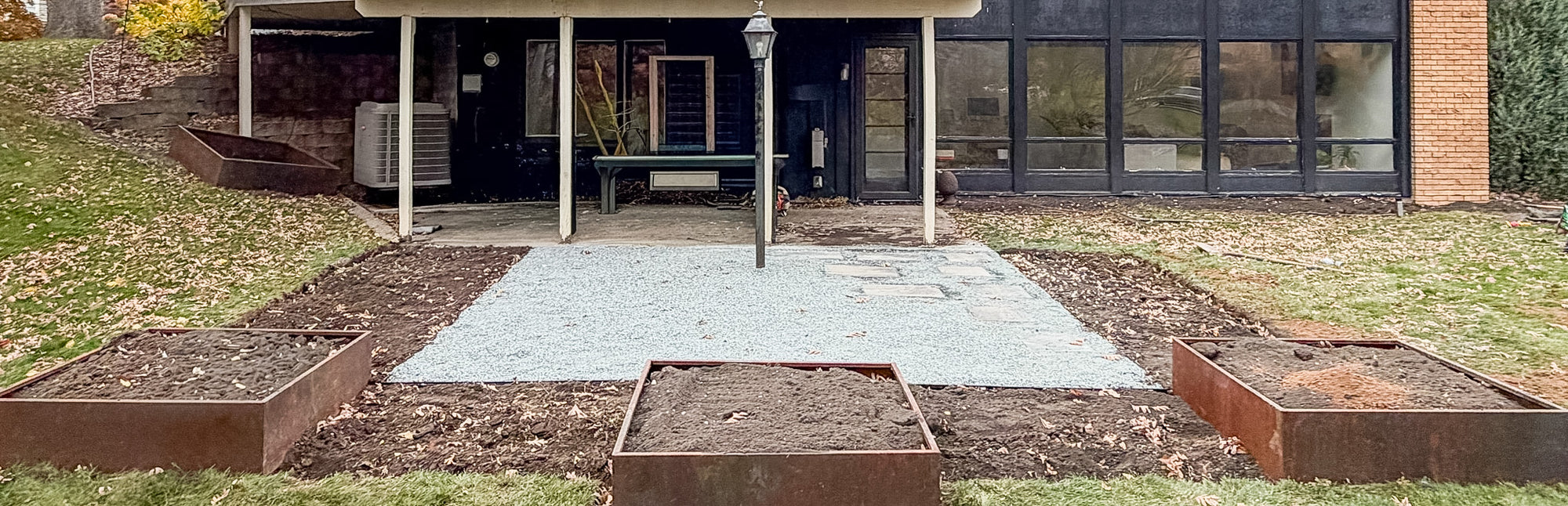 Modern backyard fire pit lounge area with crushed bluestone patio and planters in Edina Minnesota
