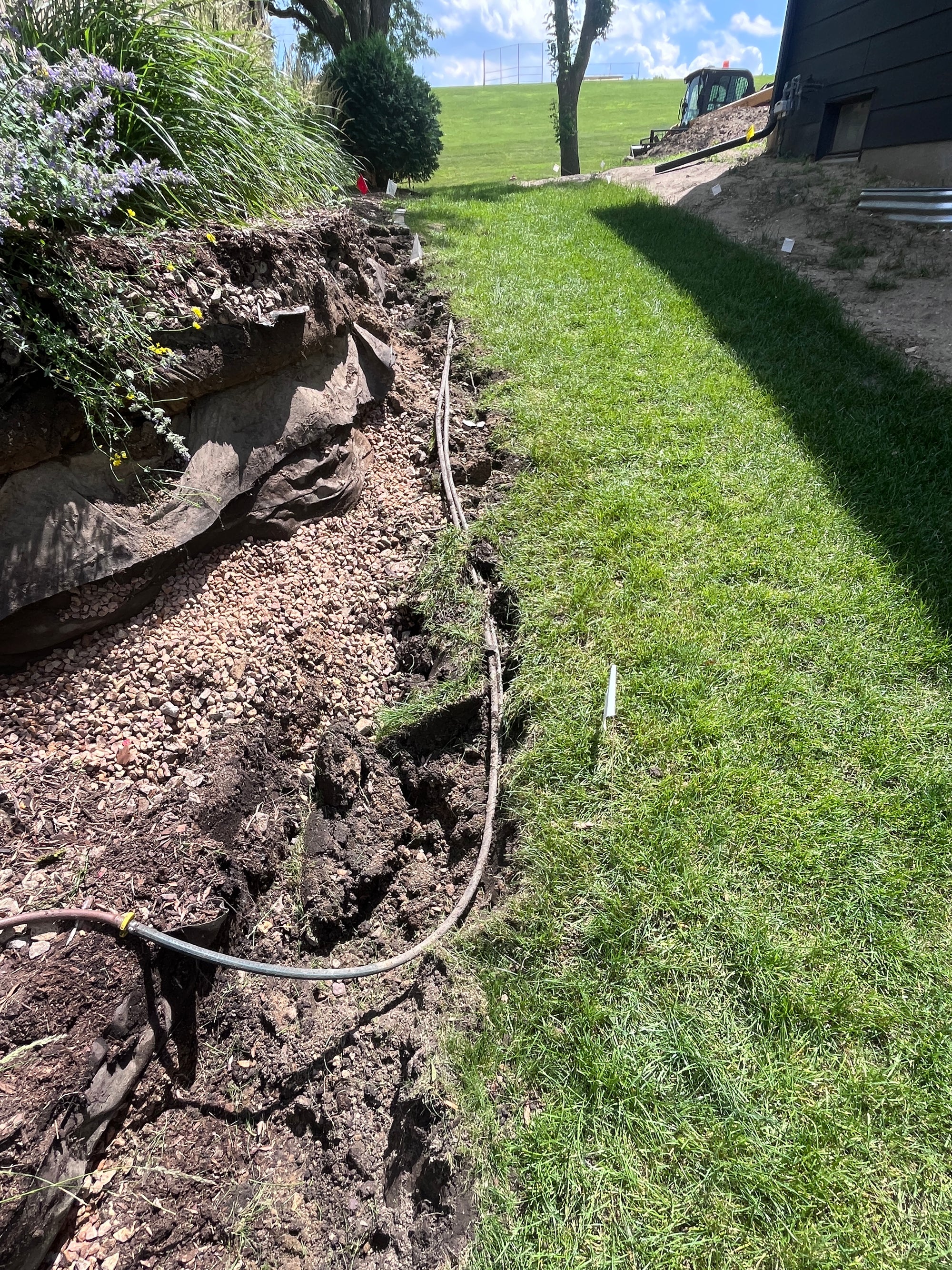 Exposed irrigation during retaining wall demolition and reconstruction in West Bloomington Minneapolis