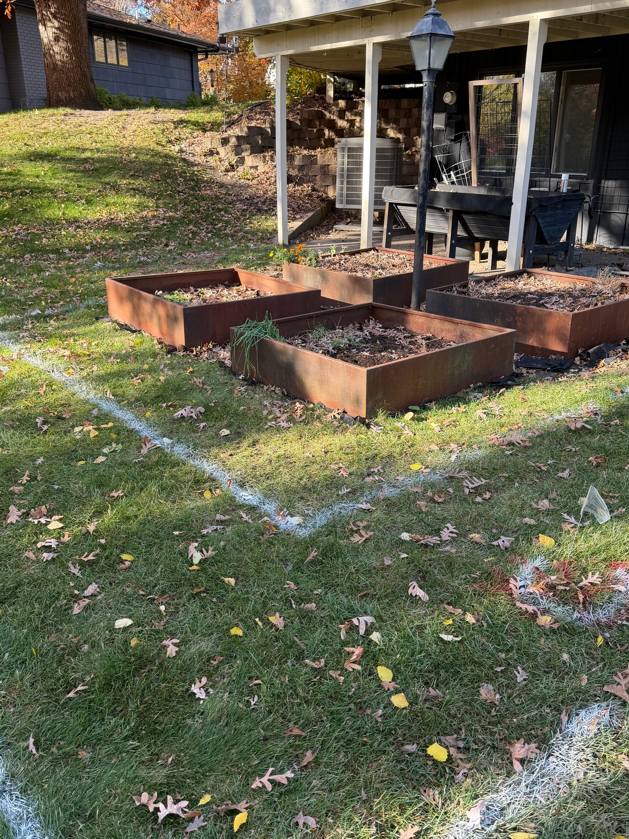 Backyard garden area during demolition and layout for new fire pit patio and seating space in Edina Minnesota